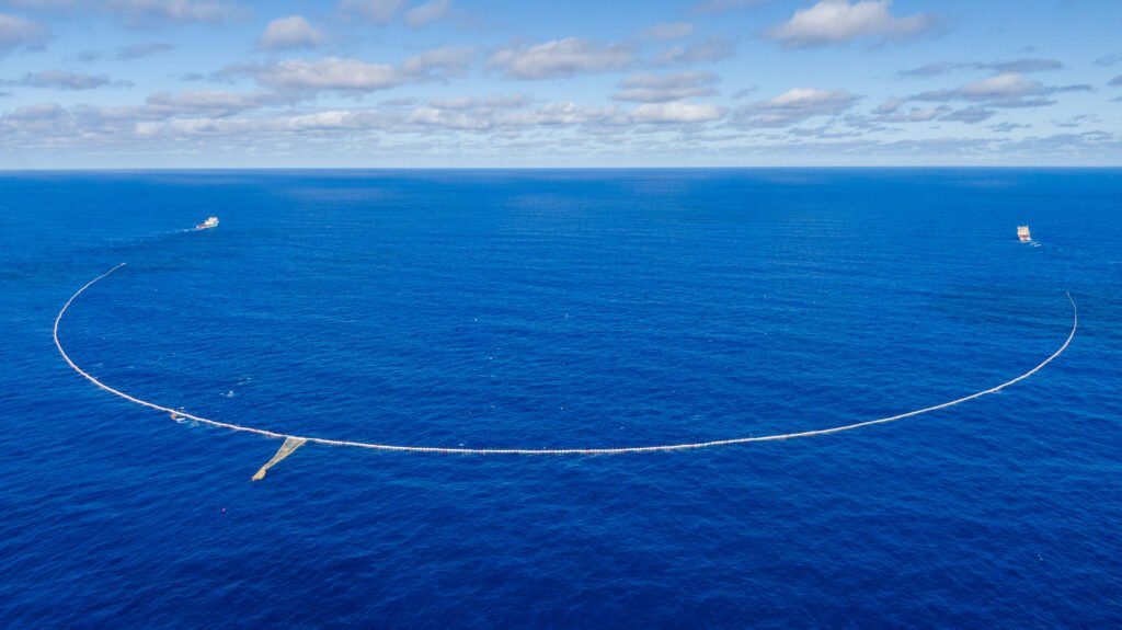 The Ocean Cleanup team removing plastic waste from the ocean to help restore healthy marine ecosystems.