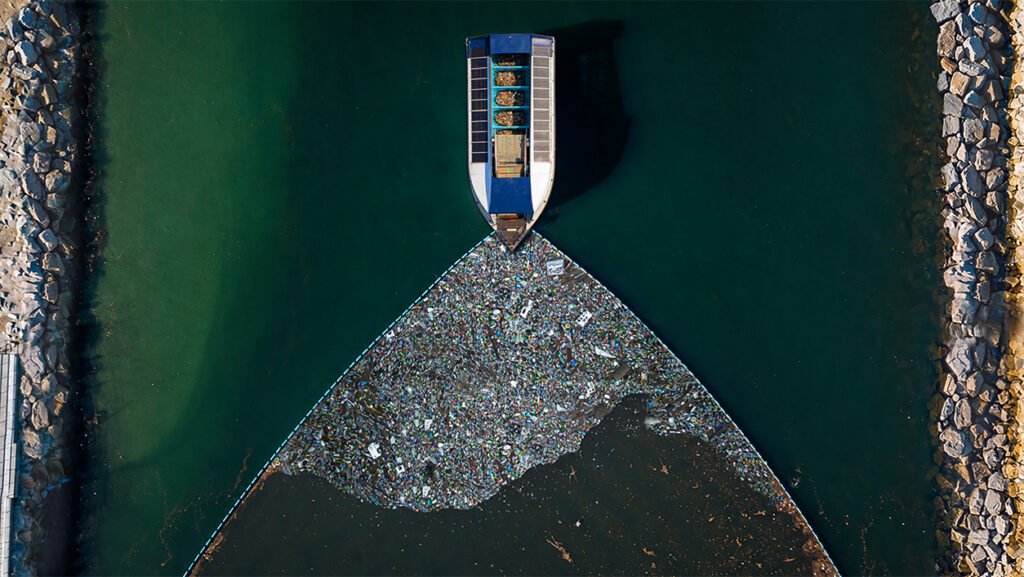 The Ocean Cleanup team removing plastic waste from the ocean to help restore healthy marine ecosystems.