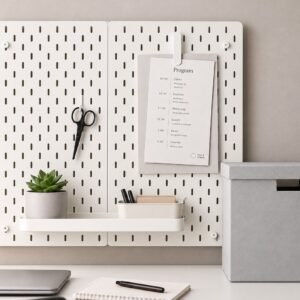 IKEA SKÅDIS white pegboard organizer with office accessories above a desk