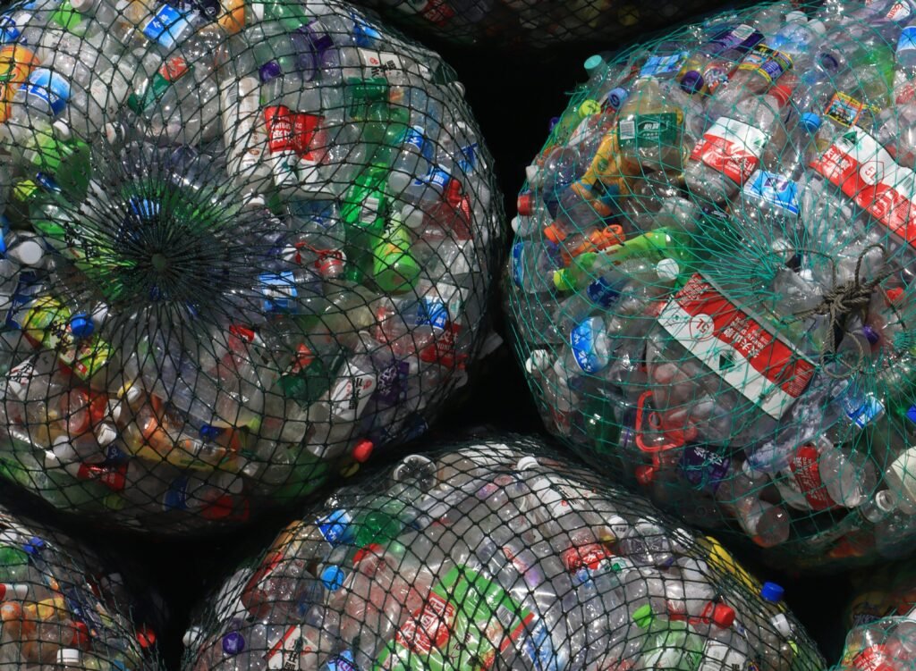 Large bundles of compressed plastic waste stacked together for disposal or recycling. the need to reduce microplastic pollution is critical
